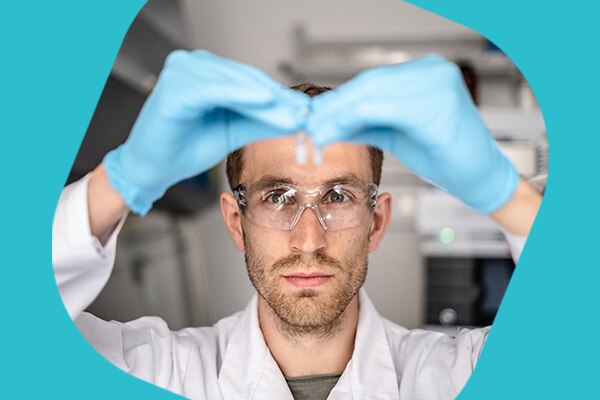 Operator analyzing a vial of mRNA encapsulated in a Lipid Nanoparticle